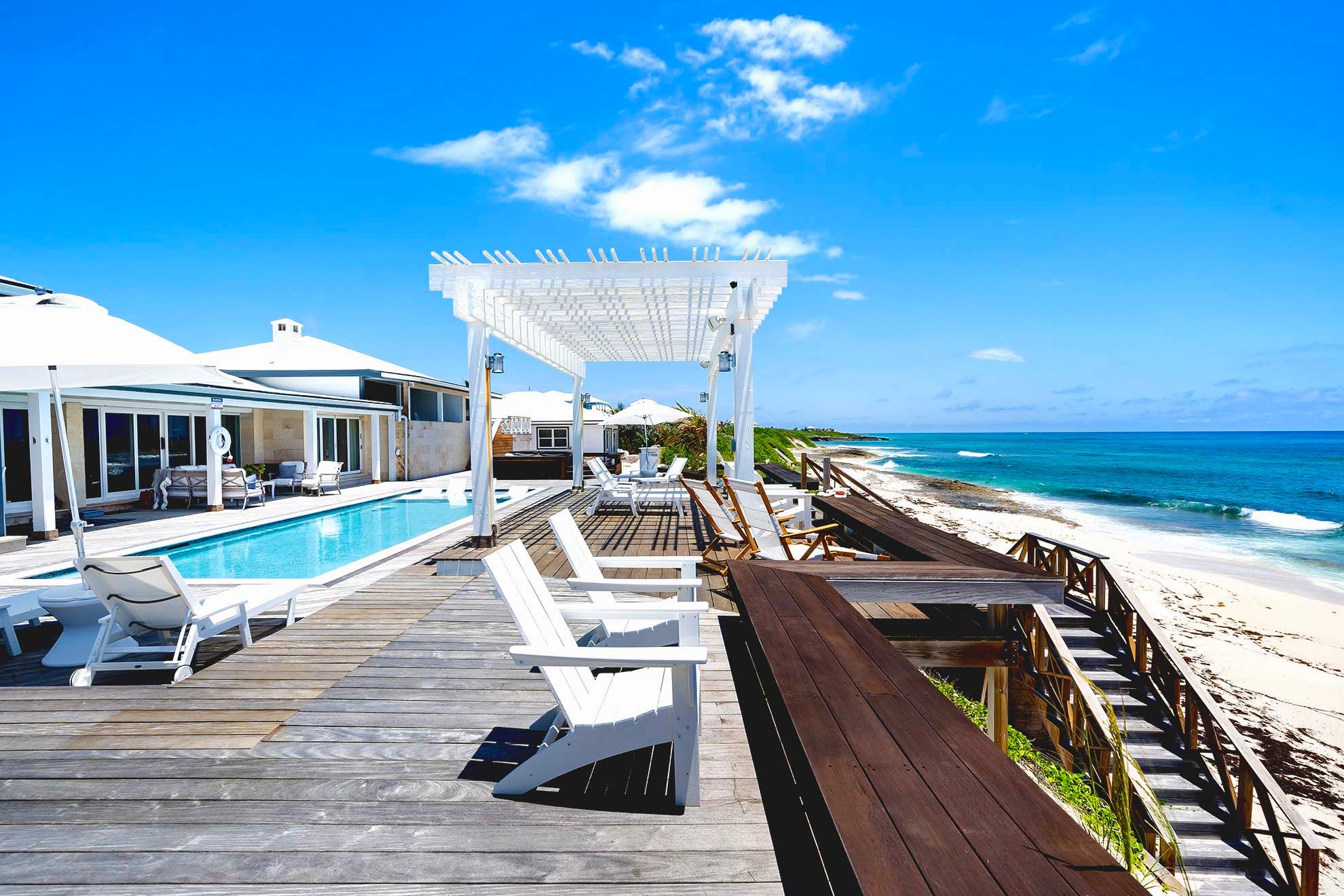 A beachside resort with a pool and ocean view