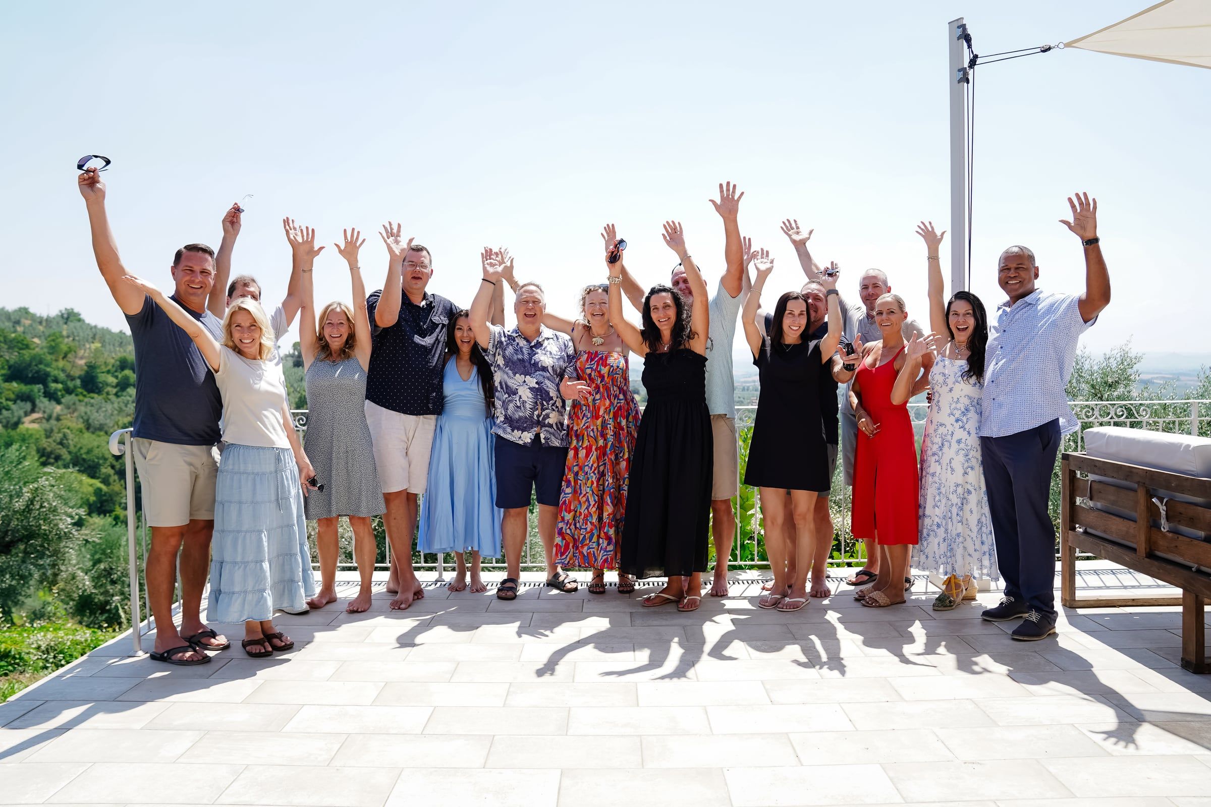 Retreat couples cheering together on a sunny terrace in Italy